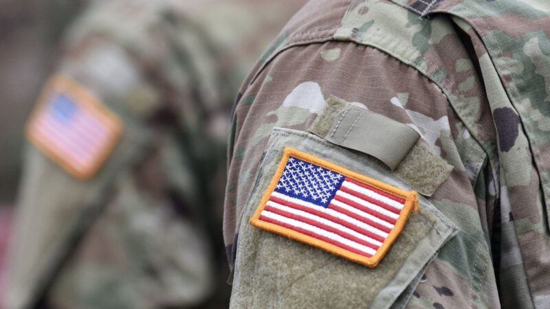 A flag on the uniform of a member of the National Guard.
