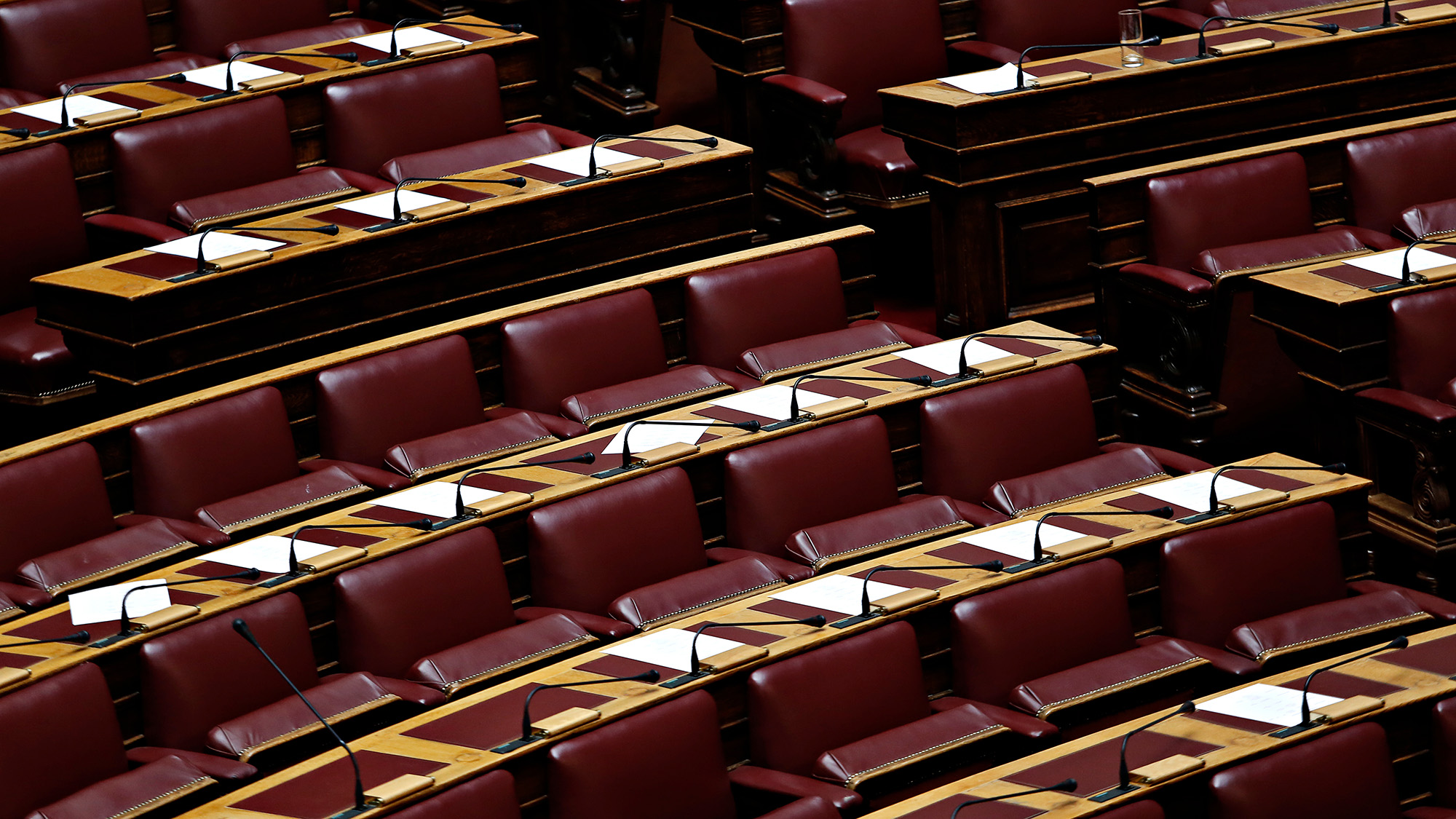 Empty seats in a congressional chamber.